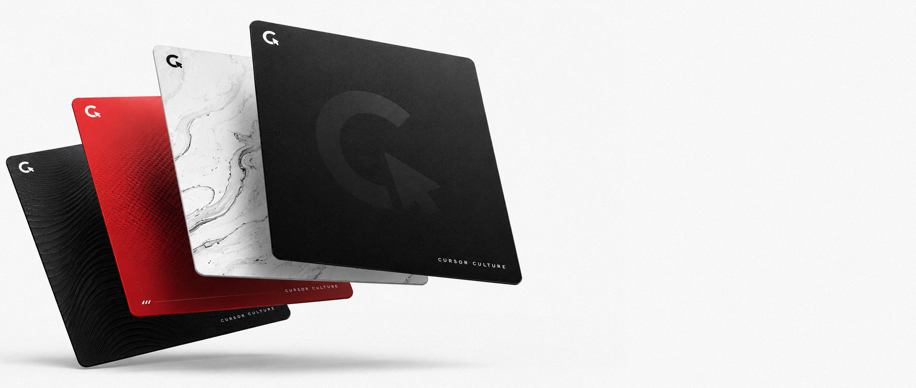 Four CursorCulture custom mousepads floating — textured black, red gradient, white marble and matte black with the cursor logo